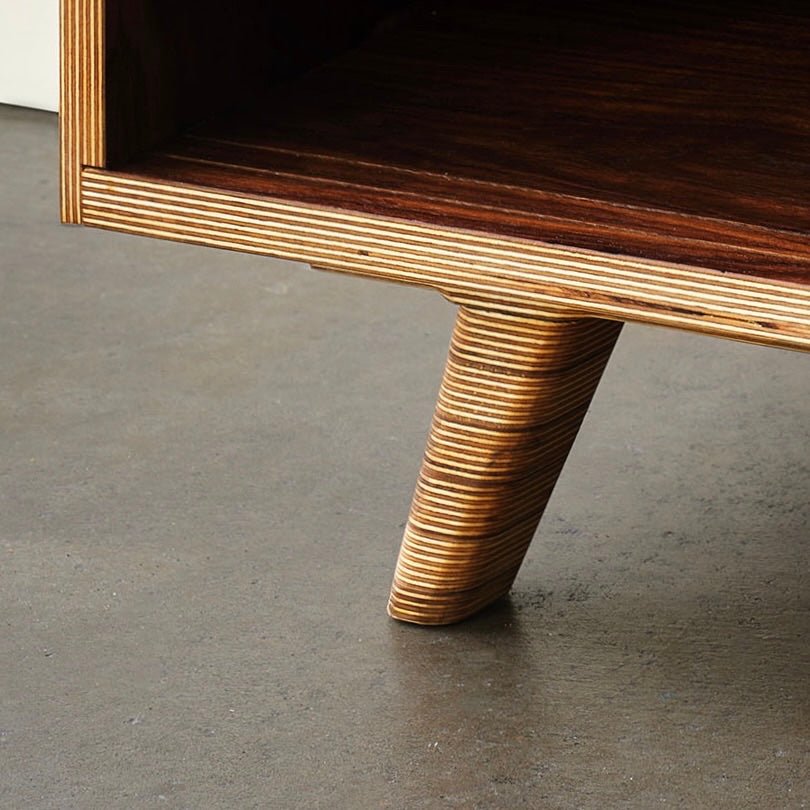 Closeup of birch plywood tapered leg and layered edge on concrete floor
