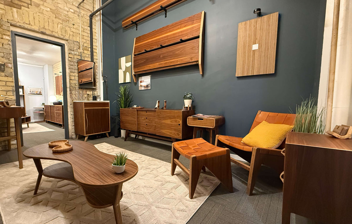 Modern living room furniture and decor in a showroom with blue and brick walls