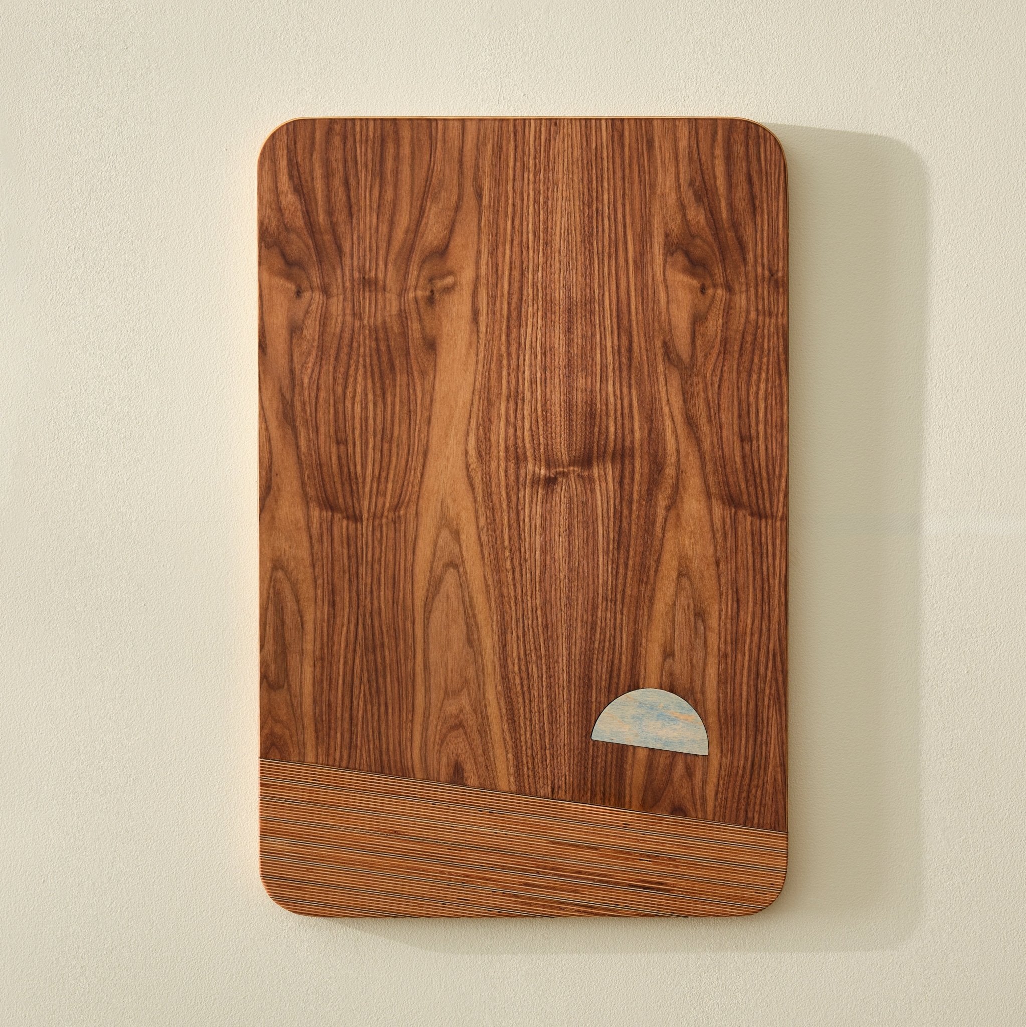 Earthrise photograph walnut art with blue half-moon sun inlay near birch base