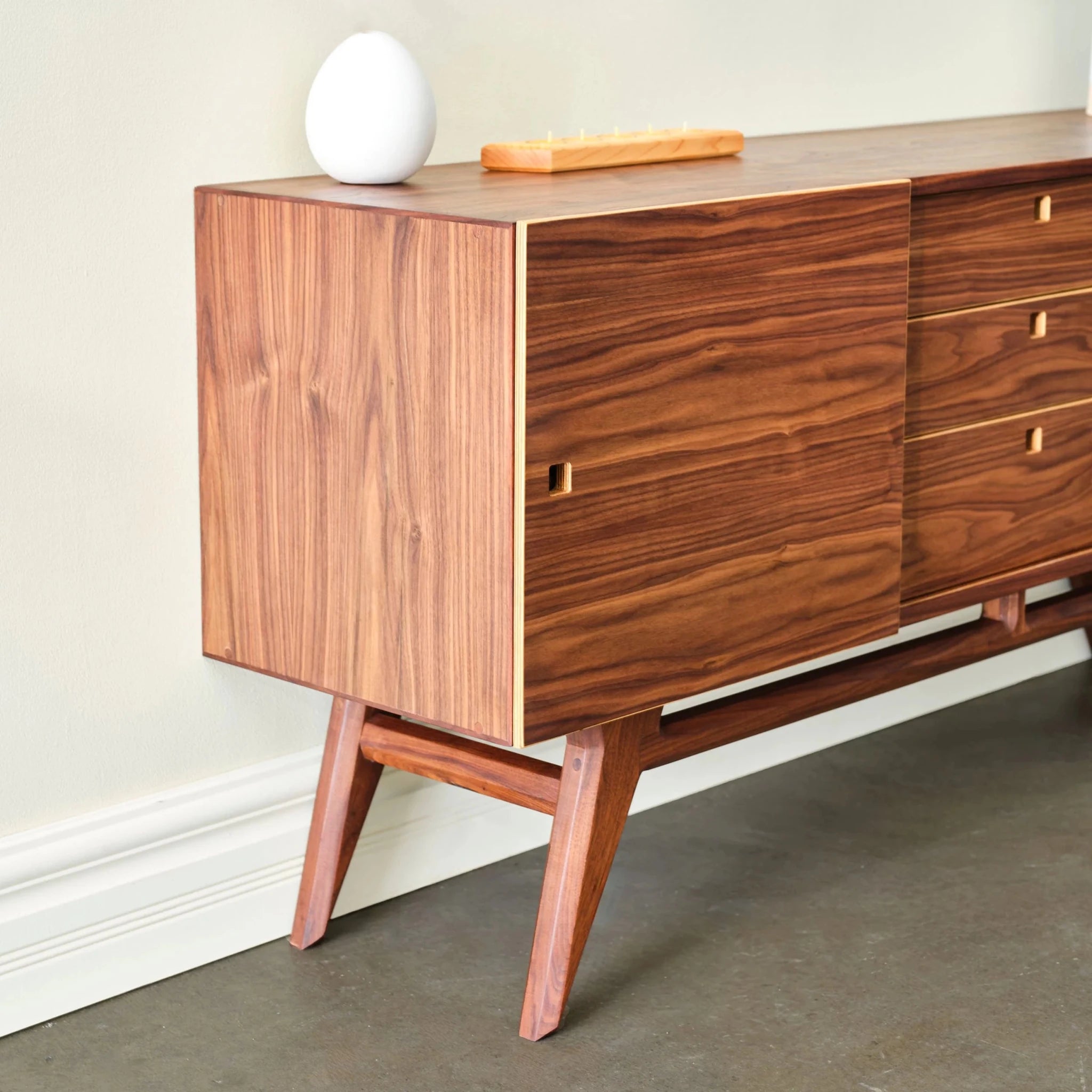 Walnut Media Console No. 2 left-end angle, sliding cabinet door, white vase and candle tray