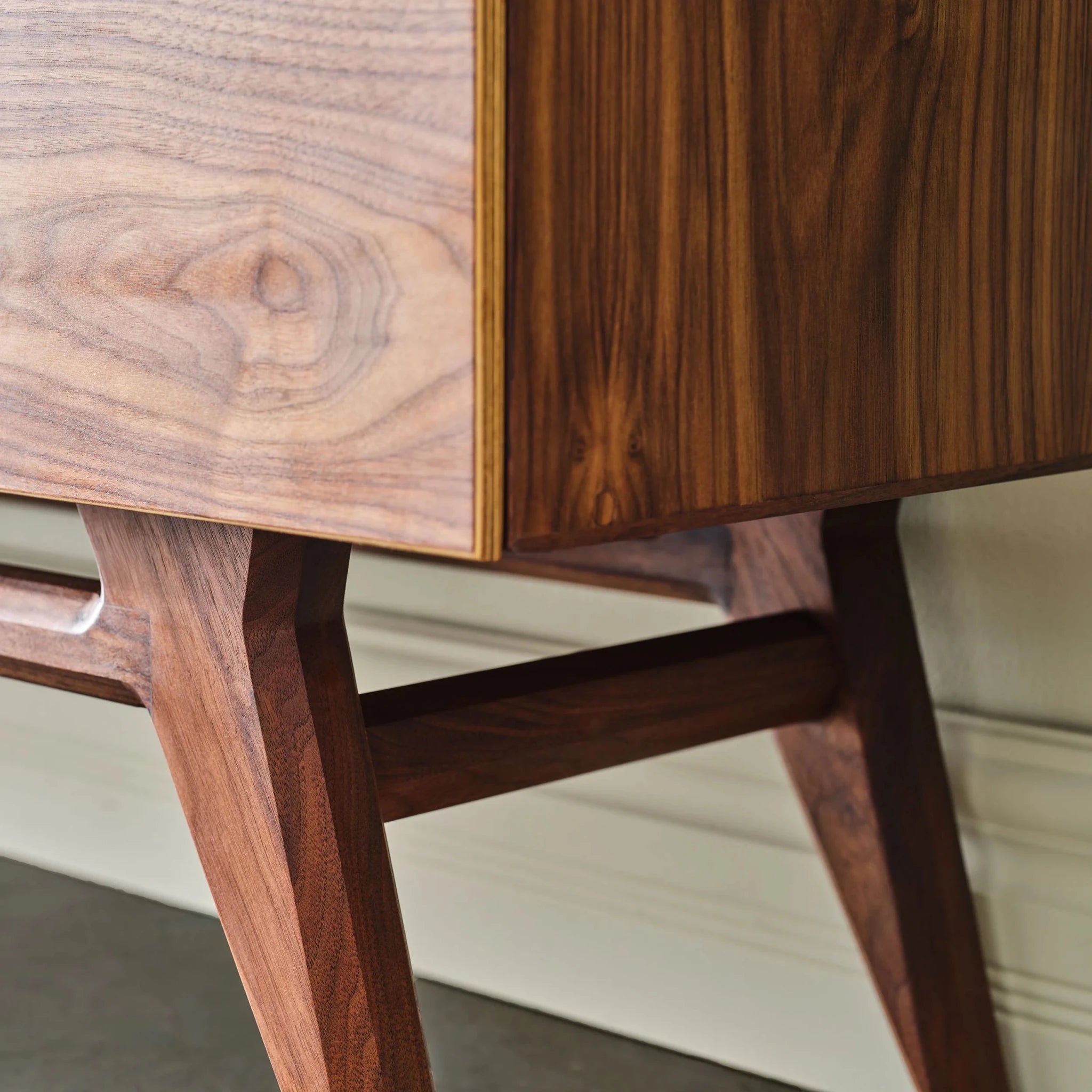 Walnut Media Console No. 2 close-up of splayed legs and cross stretcher, plywood edge visible