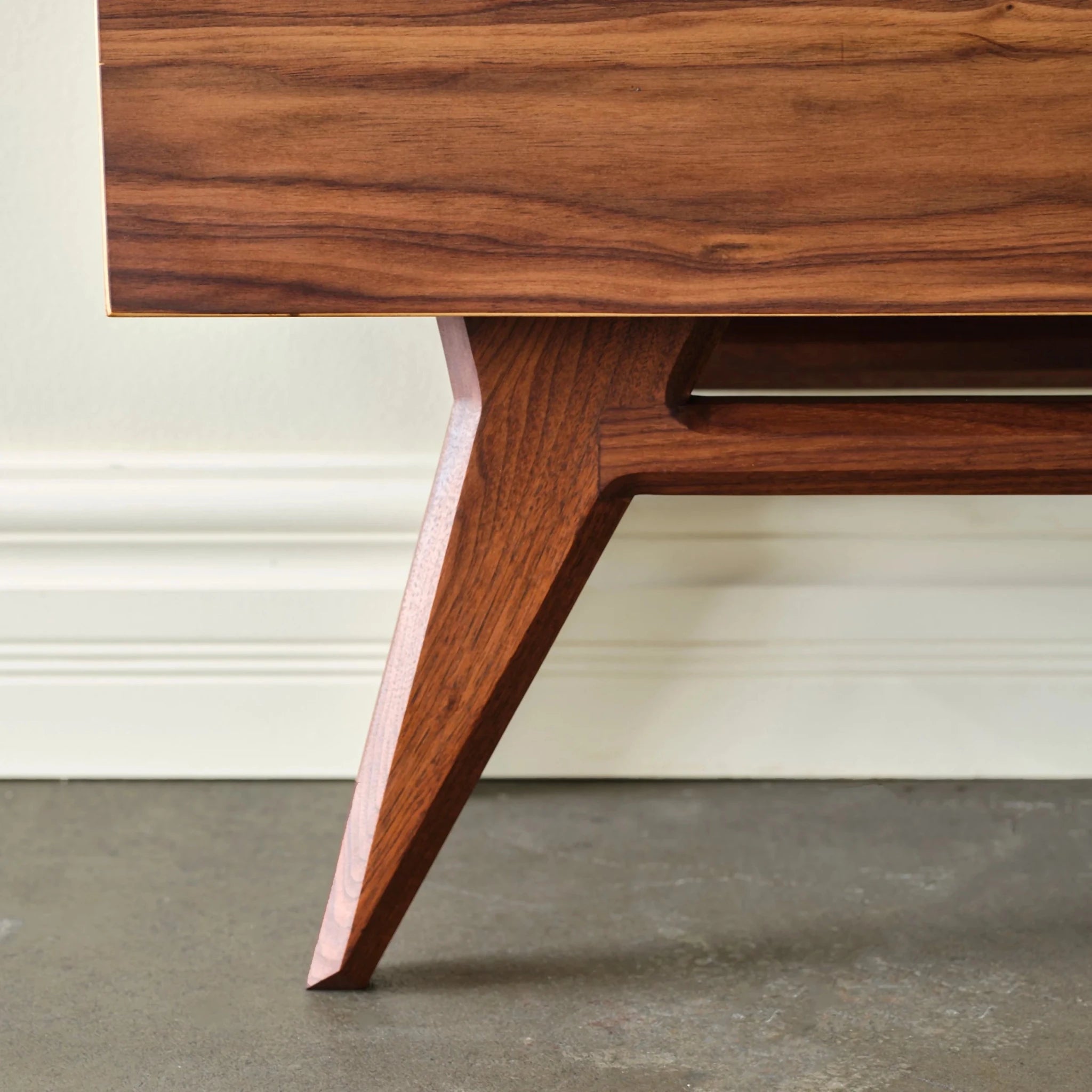 Walnut Media Console No. 2 single tapered angled leg detail on polished concrete floor