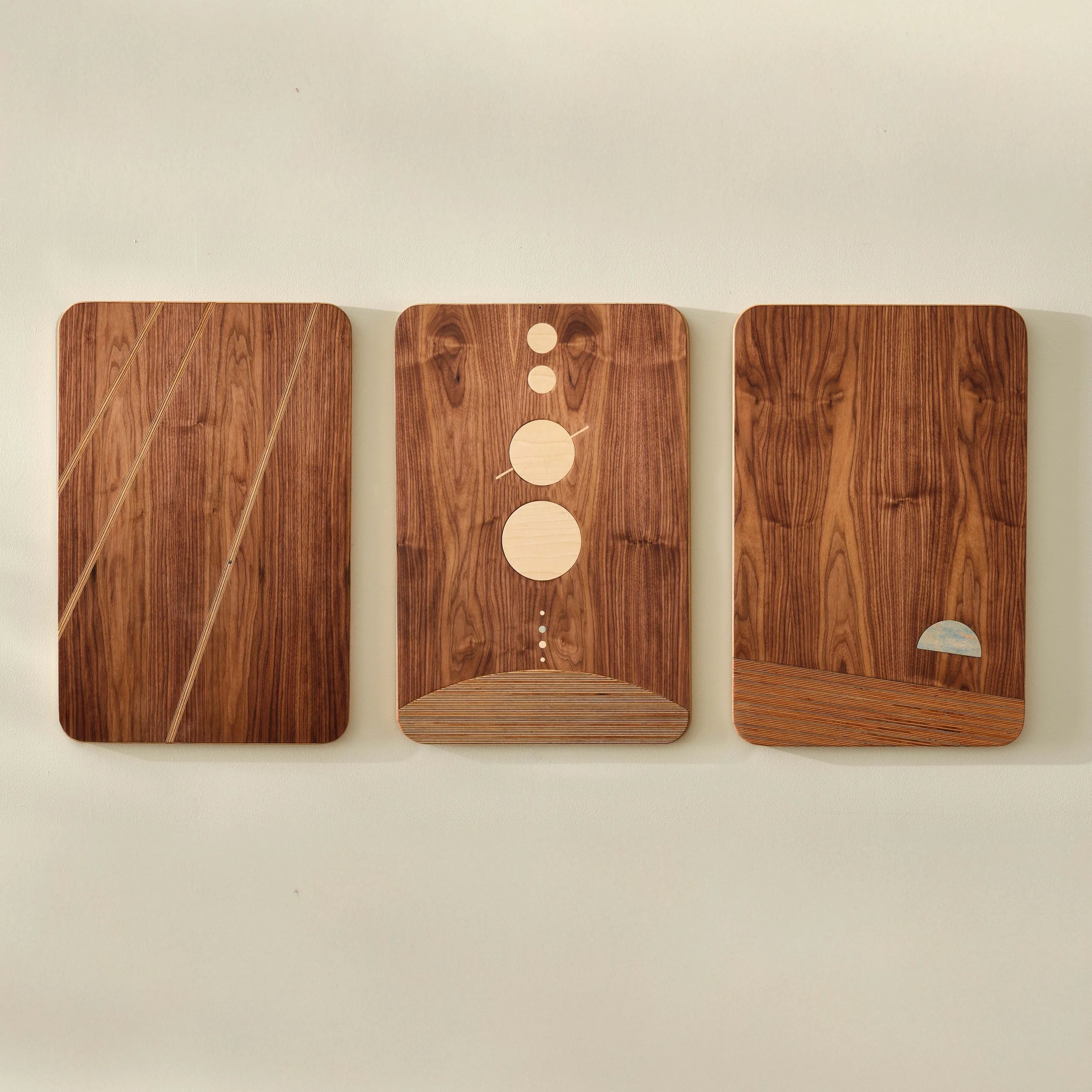 The Dot Series walnut wall art triptych with maple circle and stripe inlays