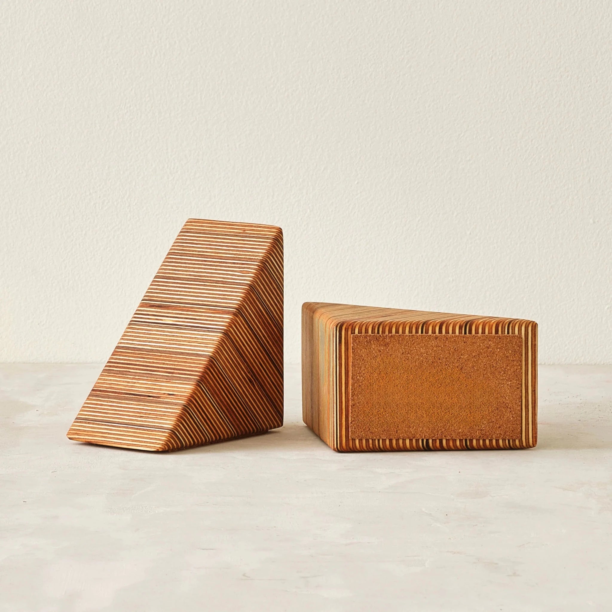Pair of wedge bookends showing striped layered Baltic birch edges and cork base