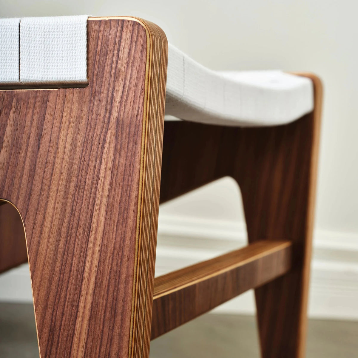 Walnut chair side panel and stretcher with birch edges and white webbing seat