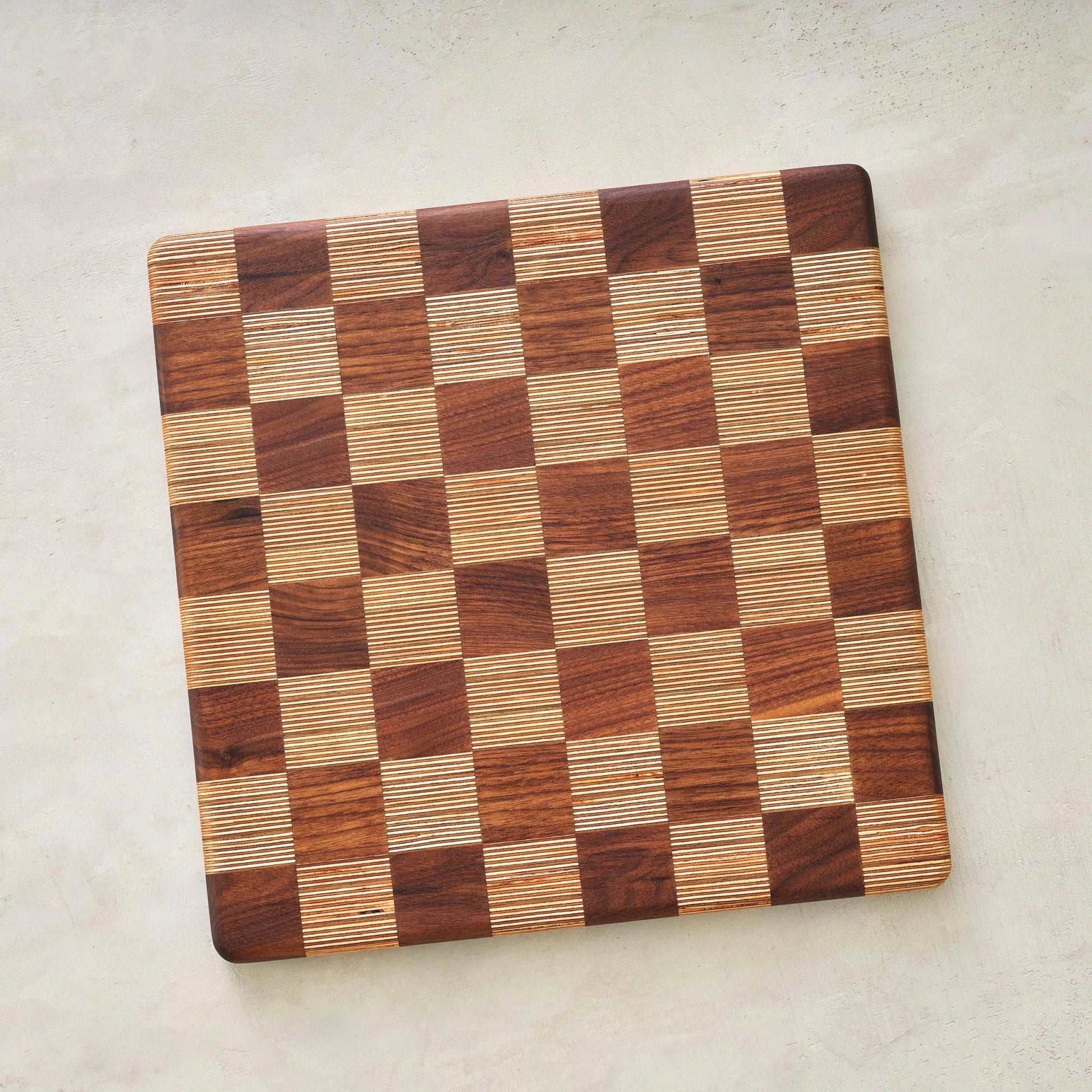 Top view of empty end-grain walnut and birch checkerboard game board