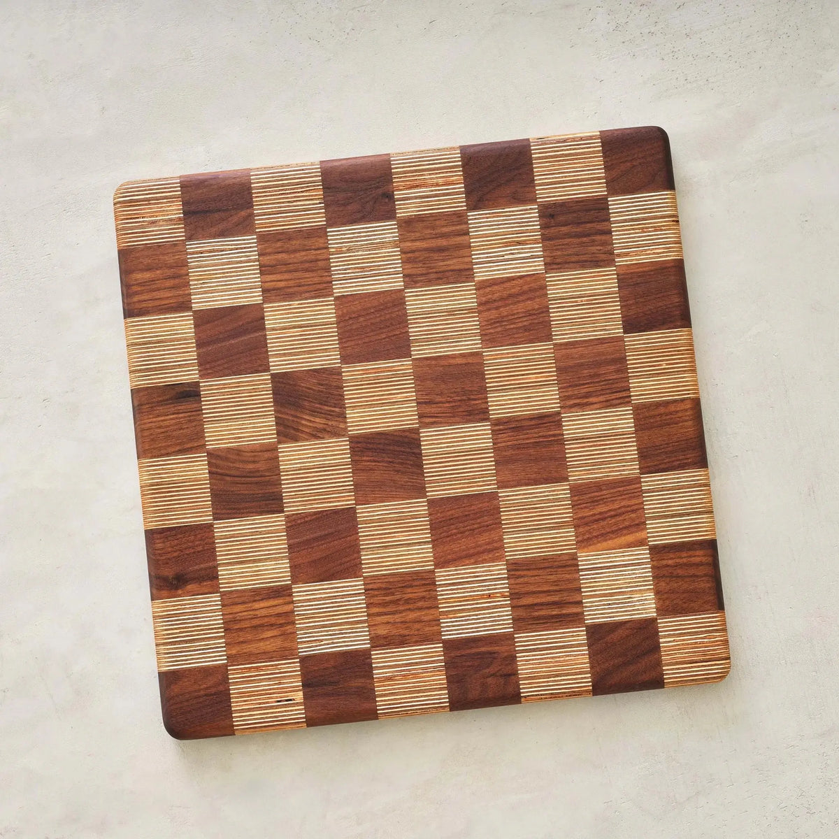 Top view of empty end-grain walnut and birch checkerboard game board