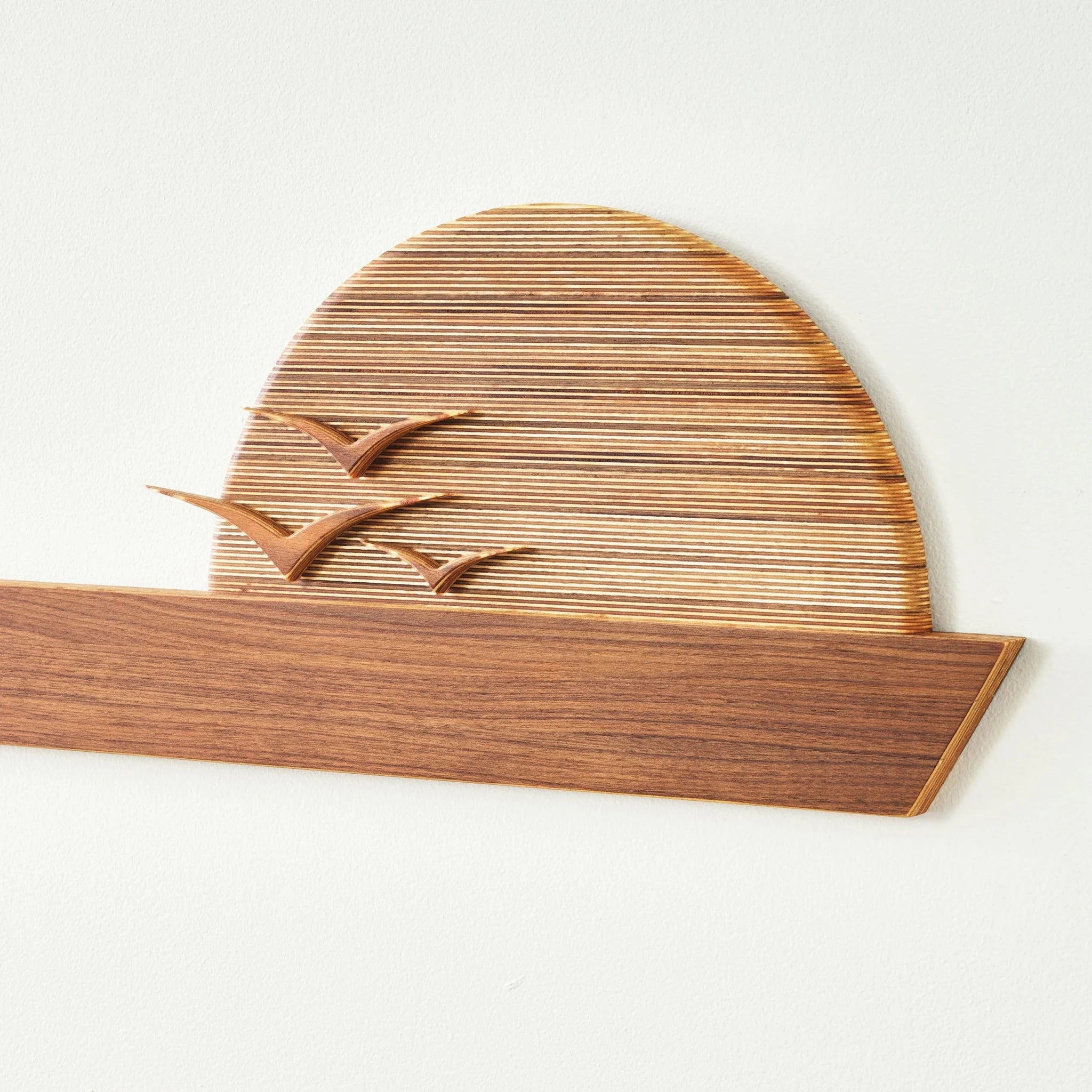 Edge of the Horizon wall sculpture close-up, walnut shelf beneath birch sunrise with flying birds