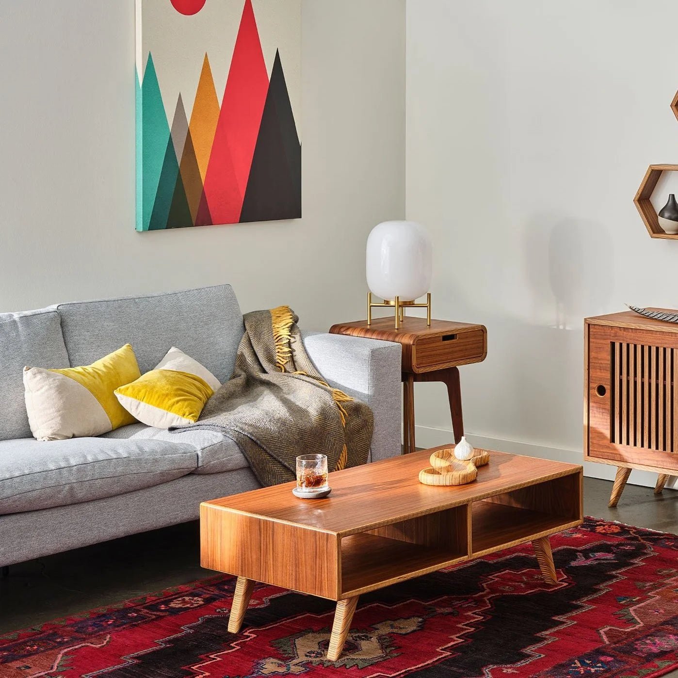 Living room walnut Coffee Table with open shelf, gray sofa, drawer side table