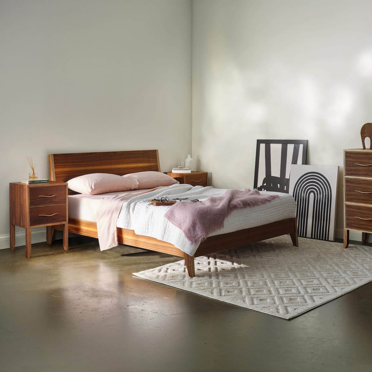 Walnut bedroom set with bed, chest dresser, and two-drawer nightstand, styled room