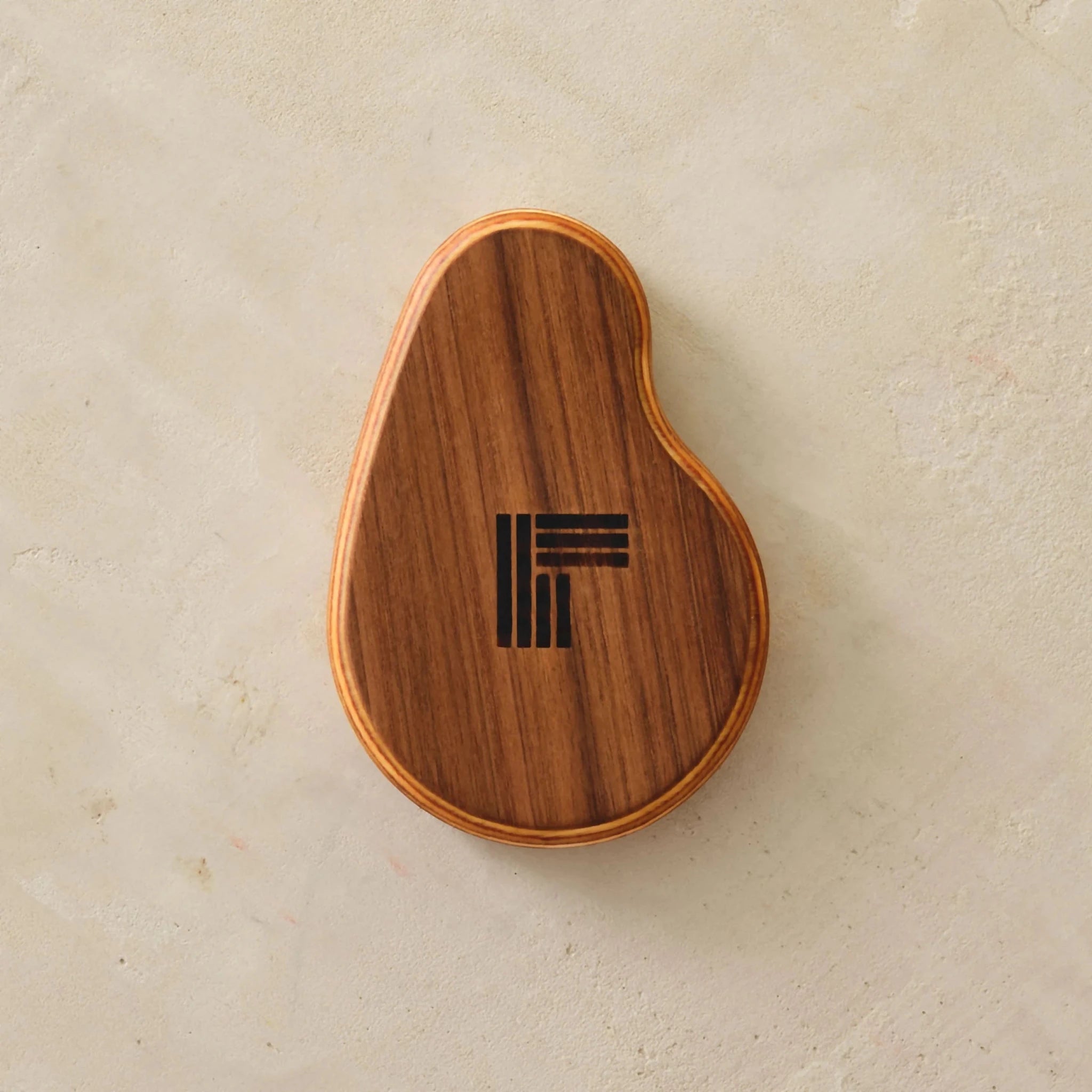 Walnut ring dish underside, overhead, branded logo engraved on Baltic birch base