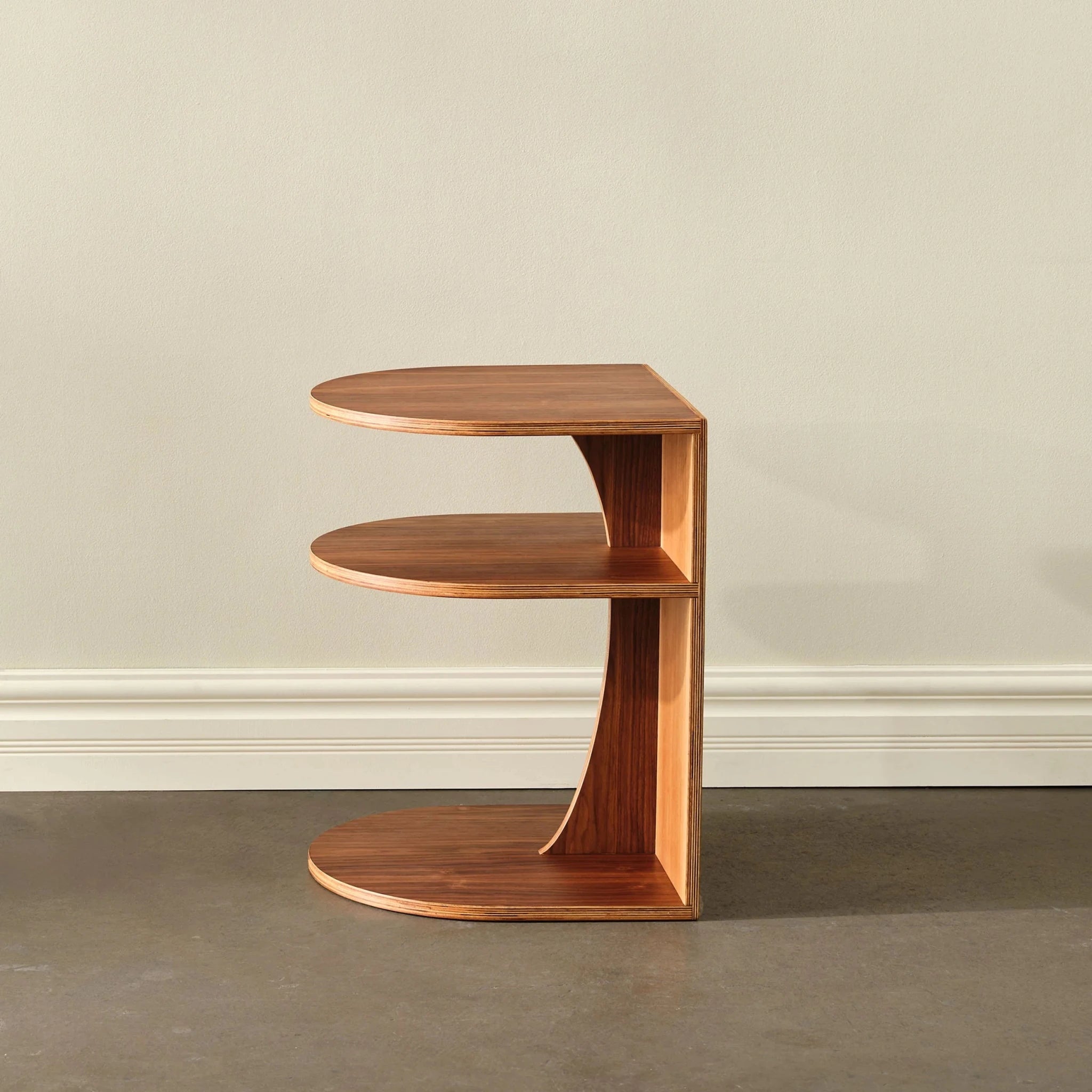 Walnut End Table No. 2 side view, two curved cantilevered plywood shelves, empty, cream wall