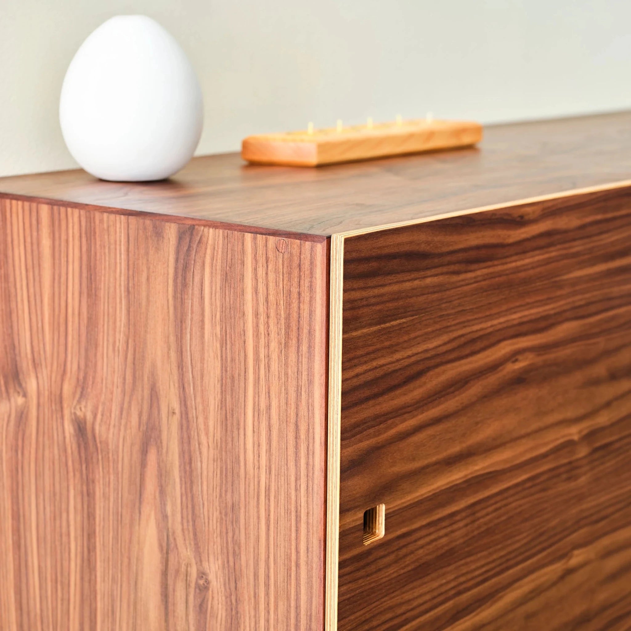 Walnut Media Console No. 2 corner detail, layered Baltic birch plywood edge, white egg vase