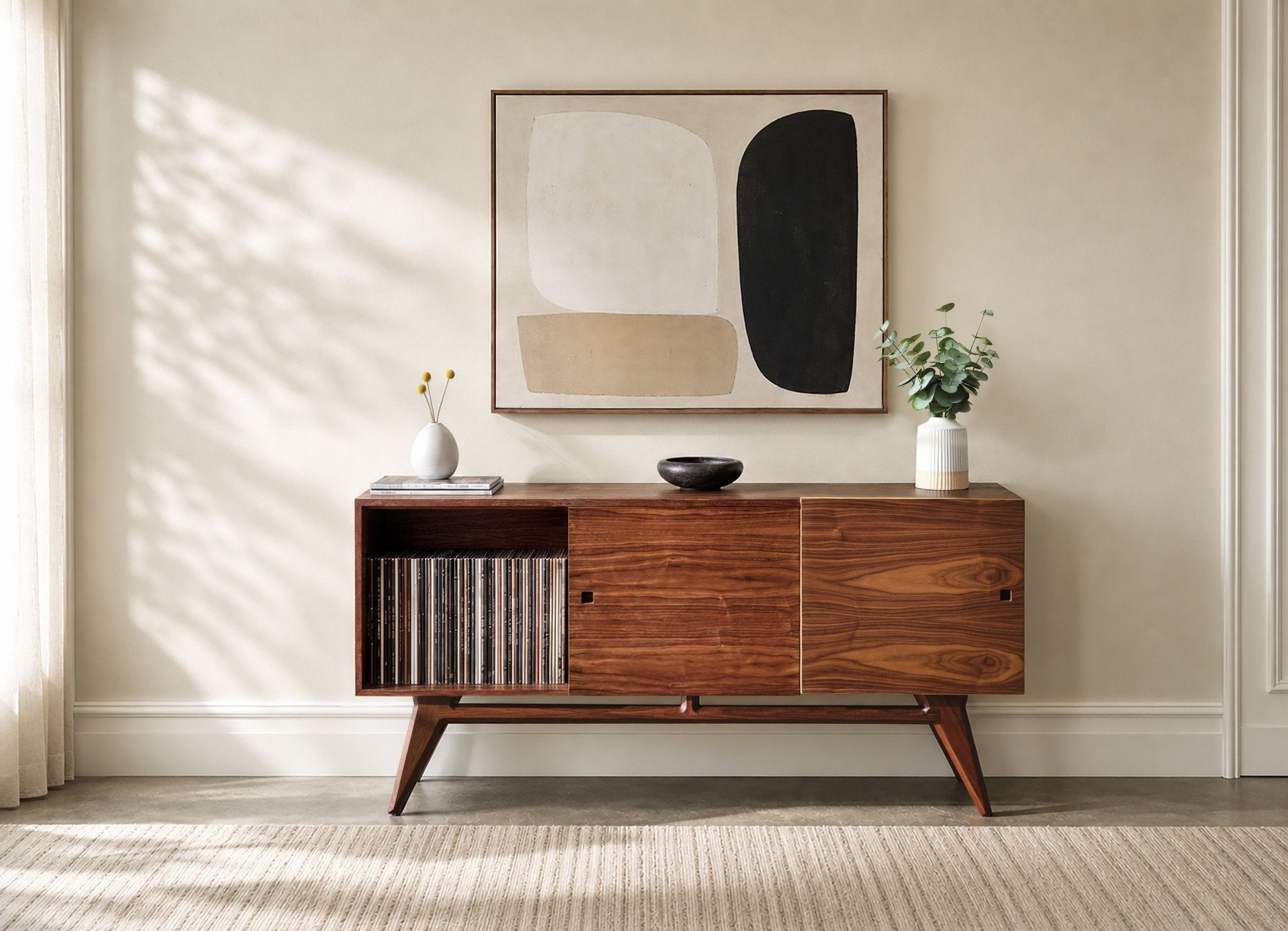 A mid-century modern wooden media console with open shelving and two cabinet doors, styled in a beige room.