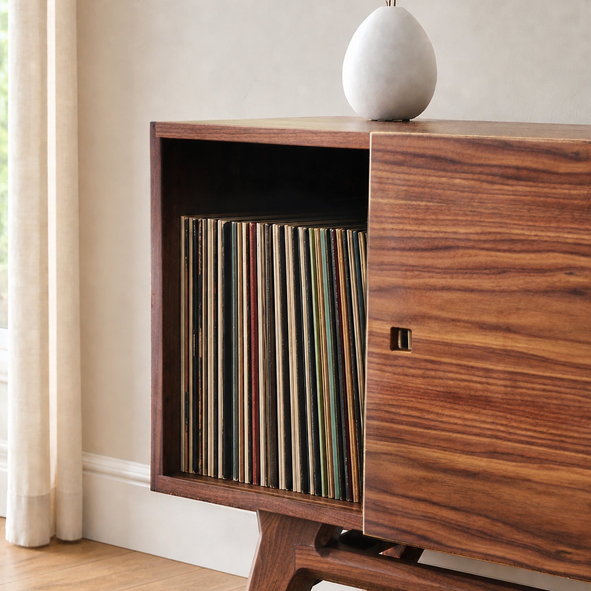 Mid-century modern wooden record cabinet with an open side displaying vinyl records