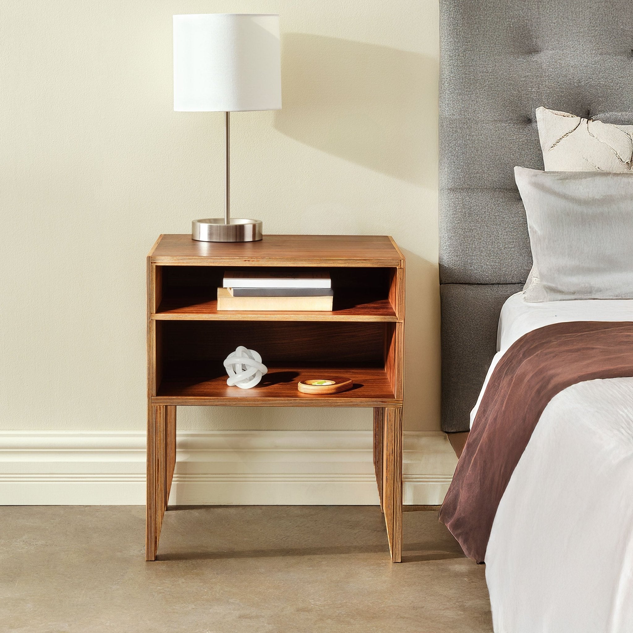 Walnut open-shelf nightstand No. 2 beside bed with lamp, books and decorative objects