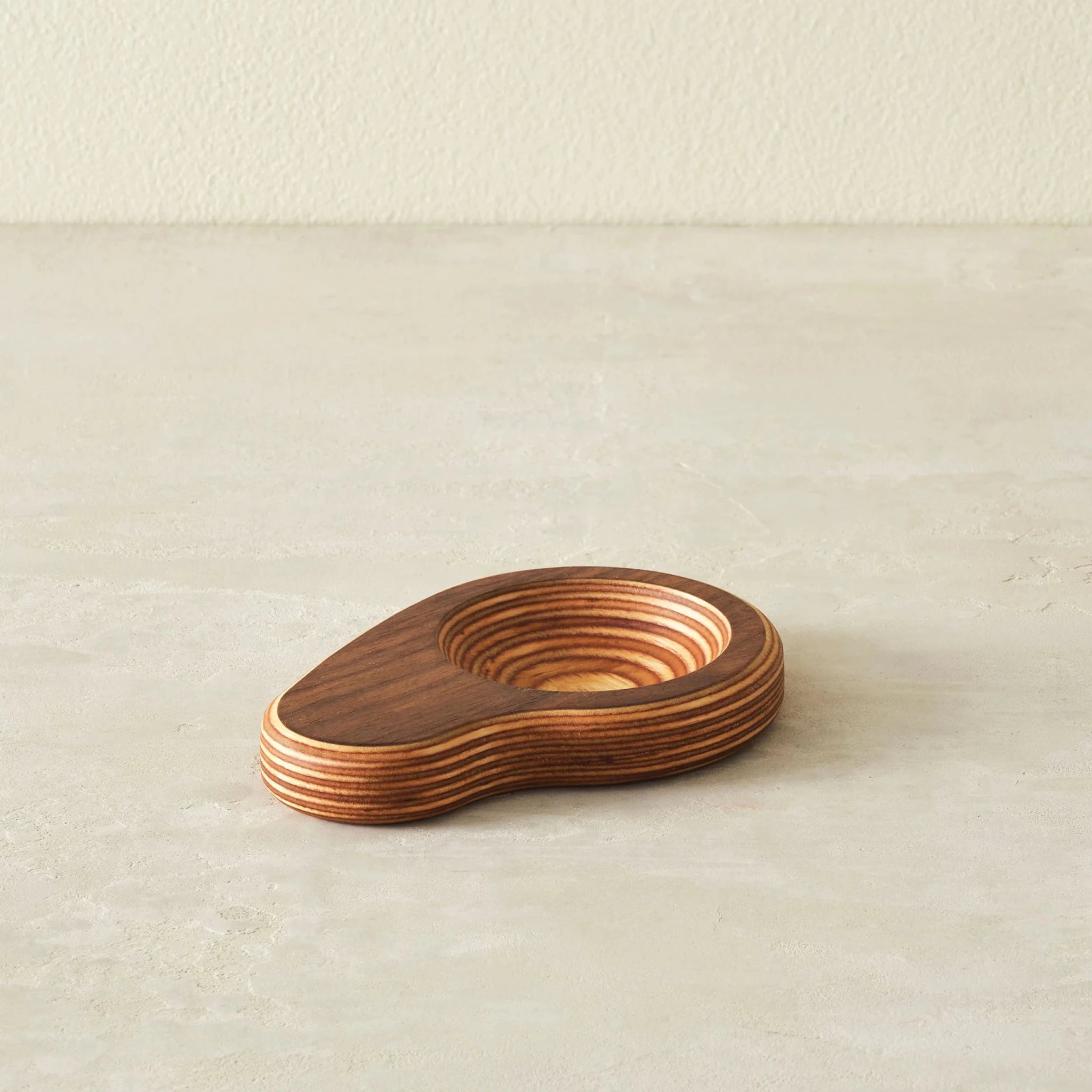 Walnut ring dish, angled view, showing layered Baltic birch edge, empty