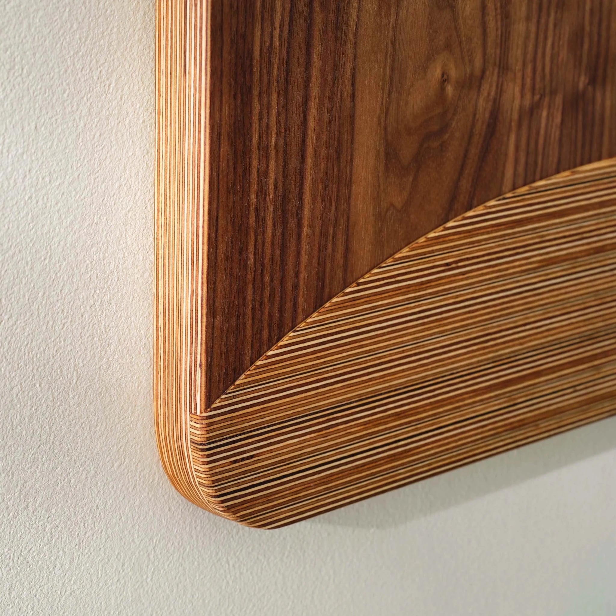 Angled corner closeup of System panel showing curved layered Baltic birch plywood edge