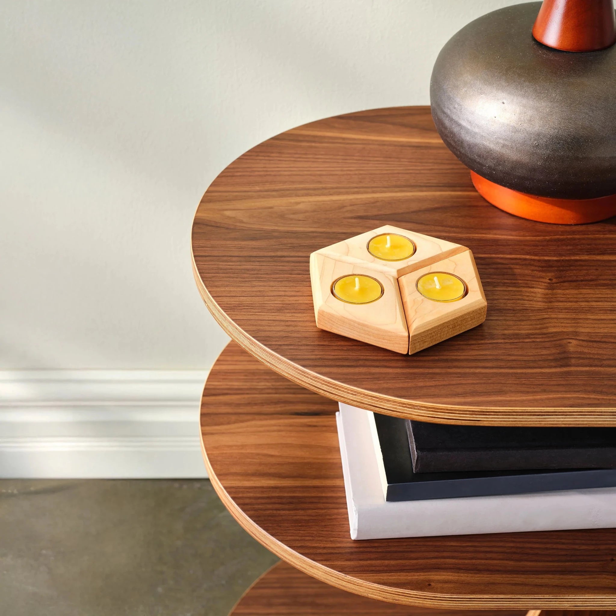 Three-piece maple tealight holder with yellow candles styled on walnut side table