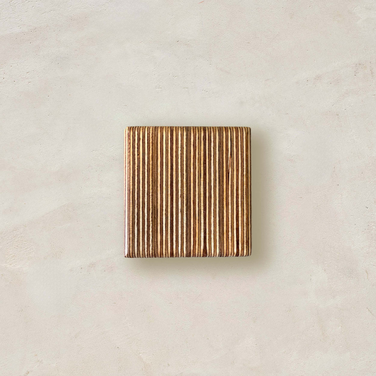 Wood sample of baltic birch with the stripes running vertically in a neutral space