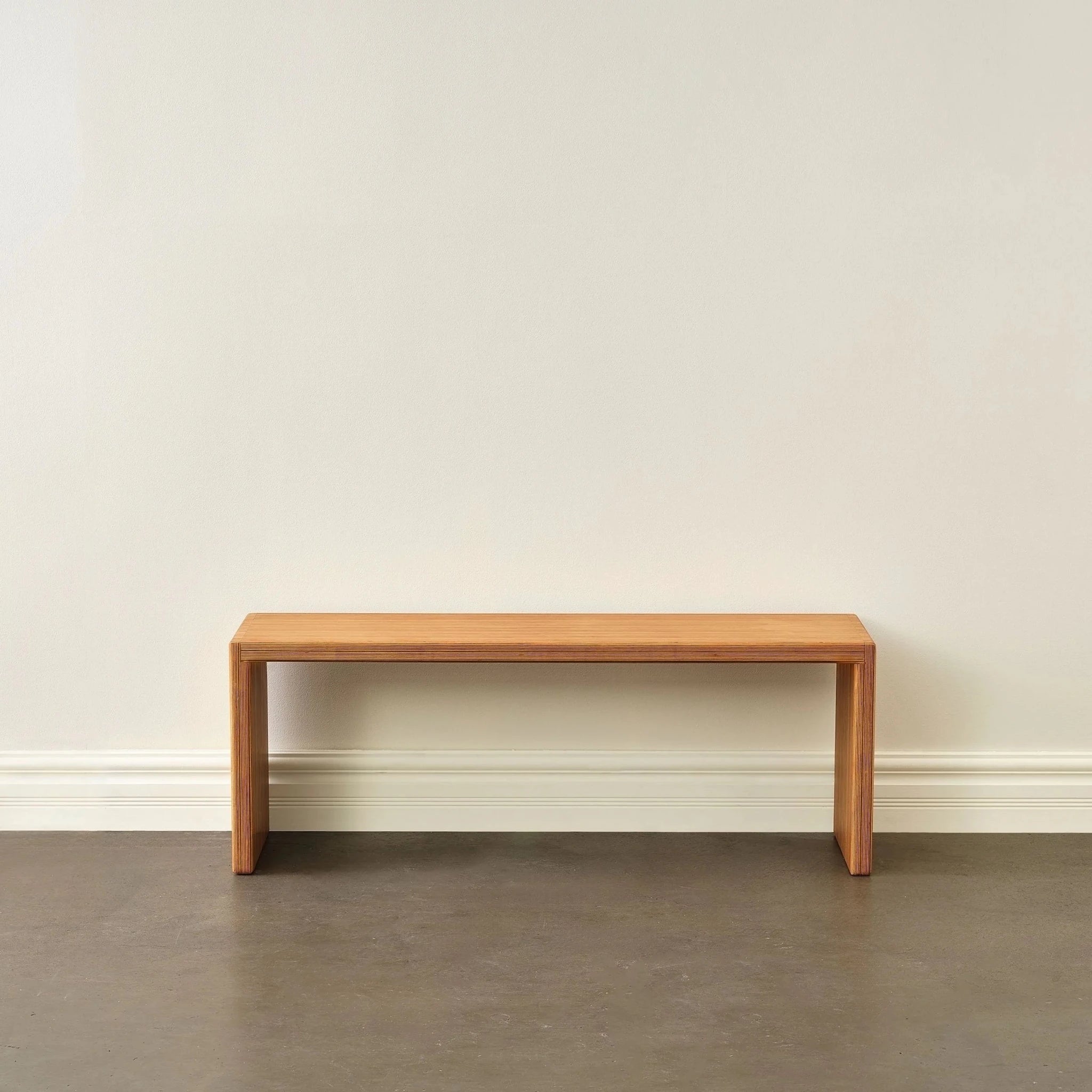 Baltic birch entryway bench, front view, waterfall edges, empty against white wall