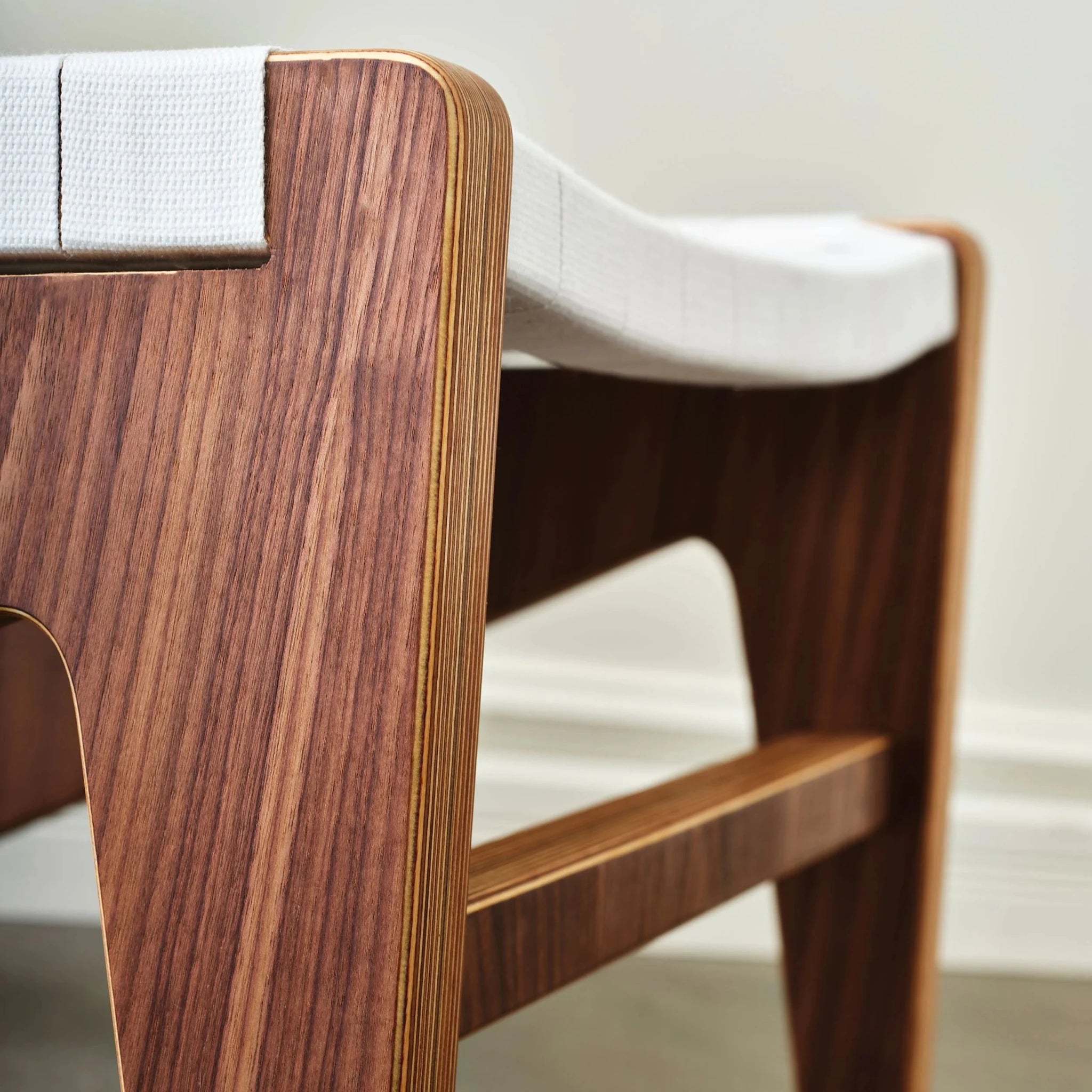 Walnut chair side panel and stretcher with birch edges and white webbing seat