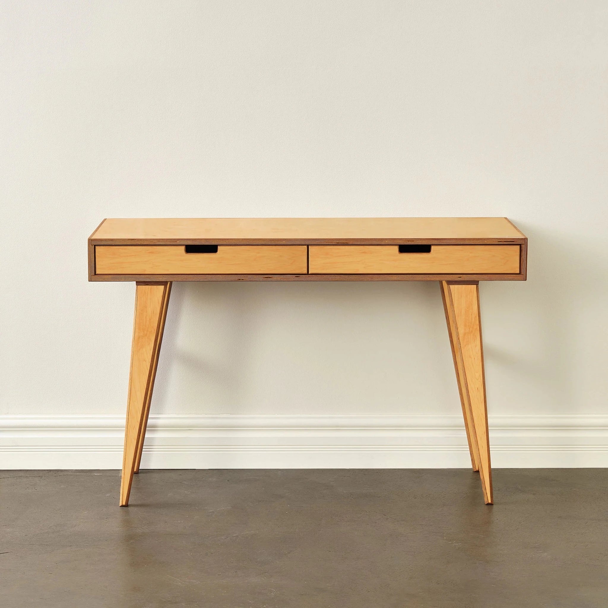Front view of light maple writing desk with two drawers, tapered legs