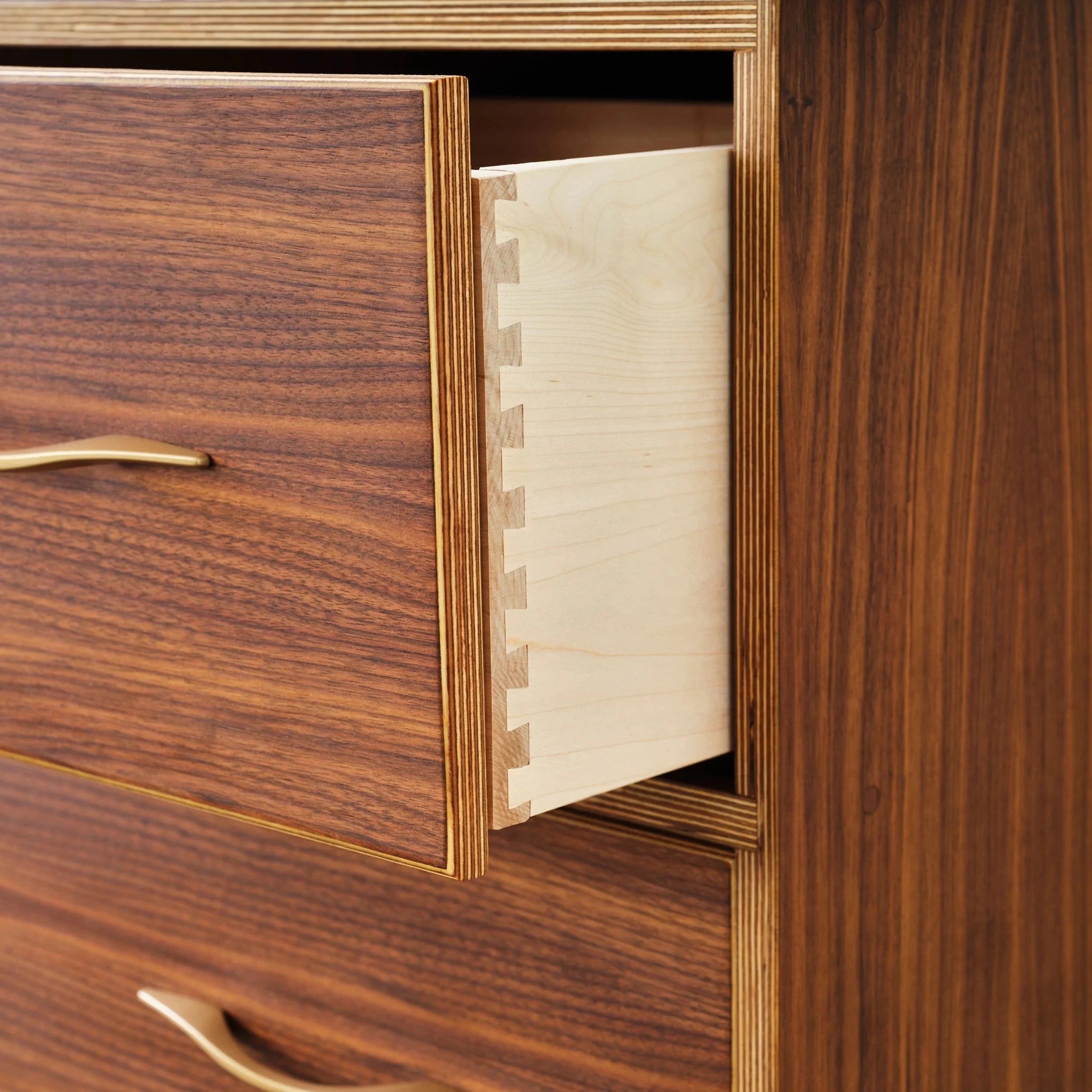 Walnut dresser with one drawer pulled open revealing dovetailed birch interior