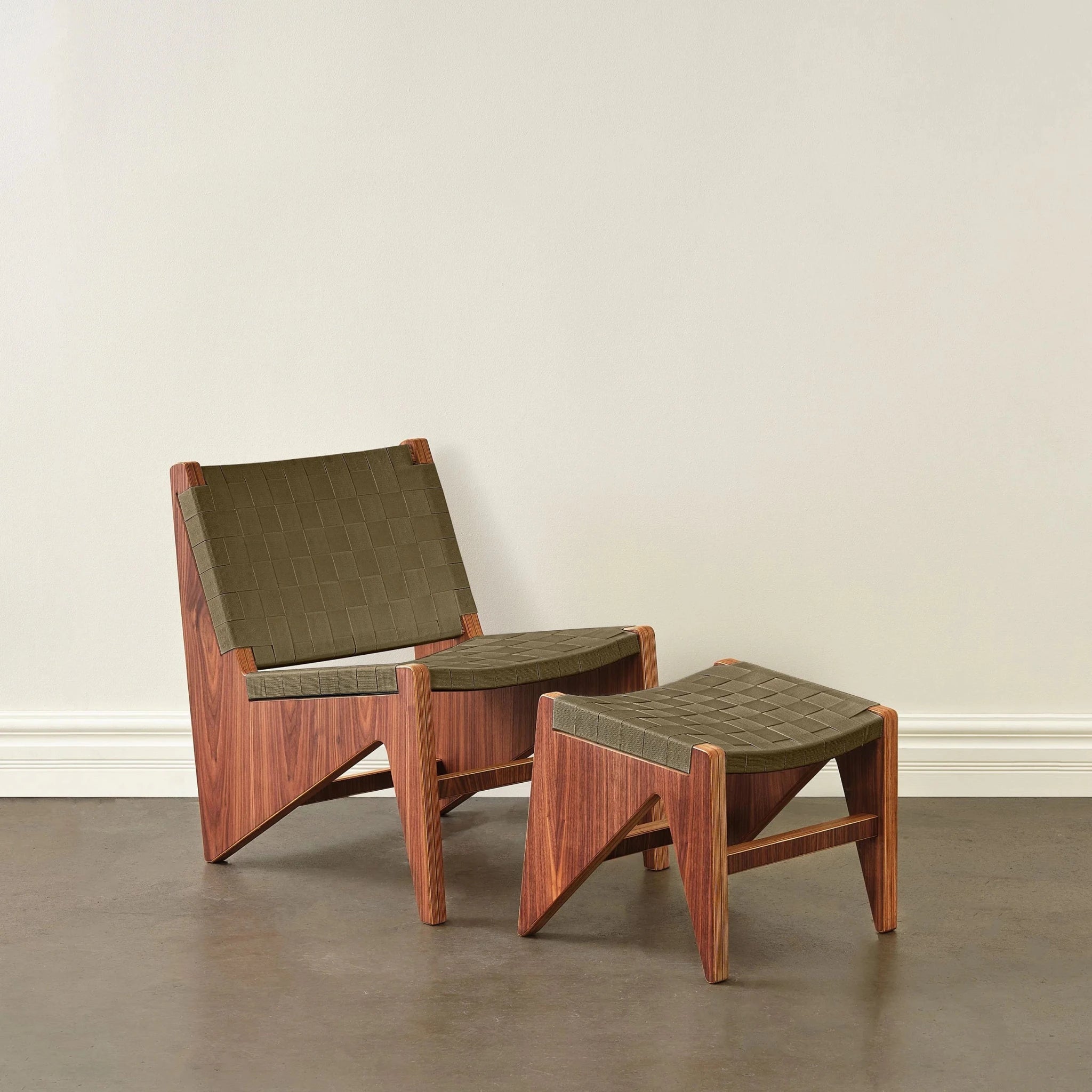 Walnut accent chair and ottoman with woven olive-green fabric straps, front view, neutral background