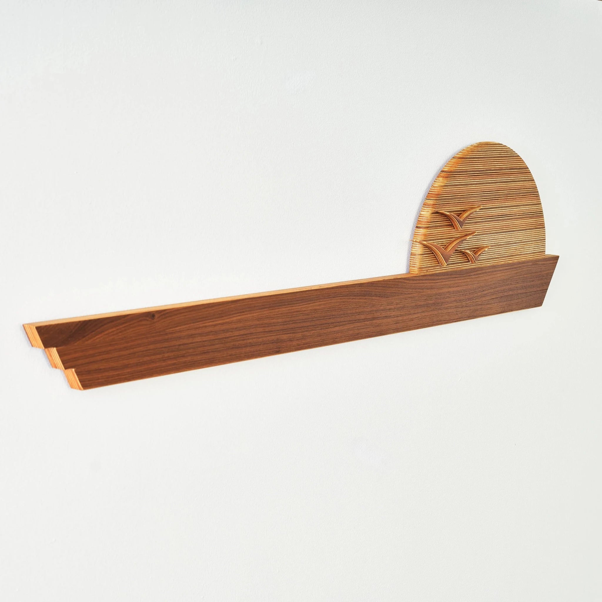 Edge of the Horizon wall sculpture, angled view, walnut ledge with layered birch sun, birds