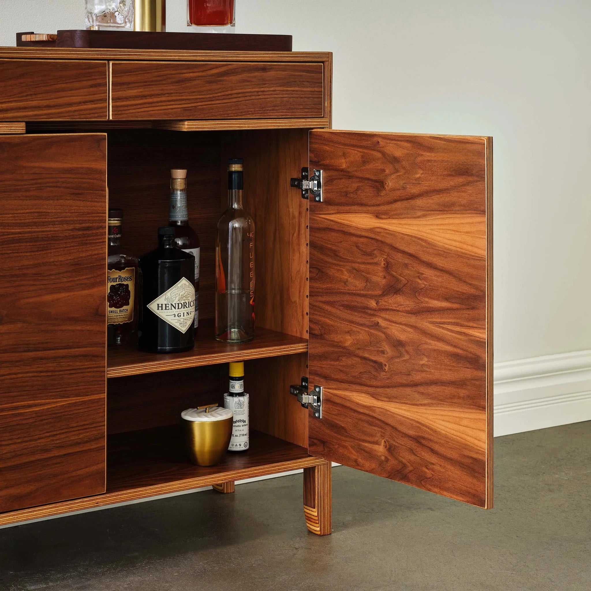Walnut liquor cabinet right door open showing liquor bottles on shelves