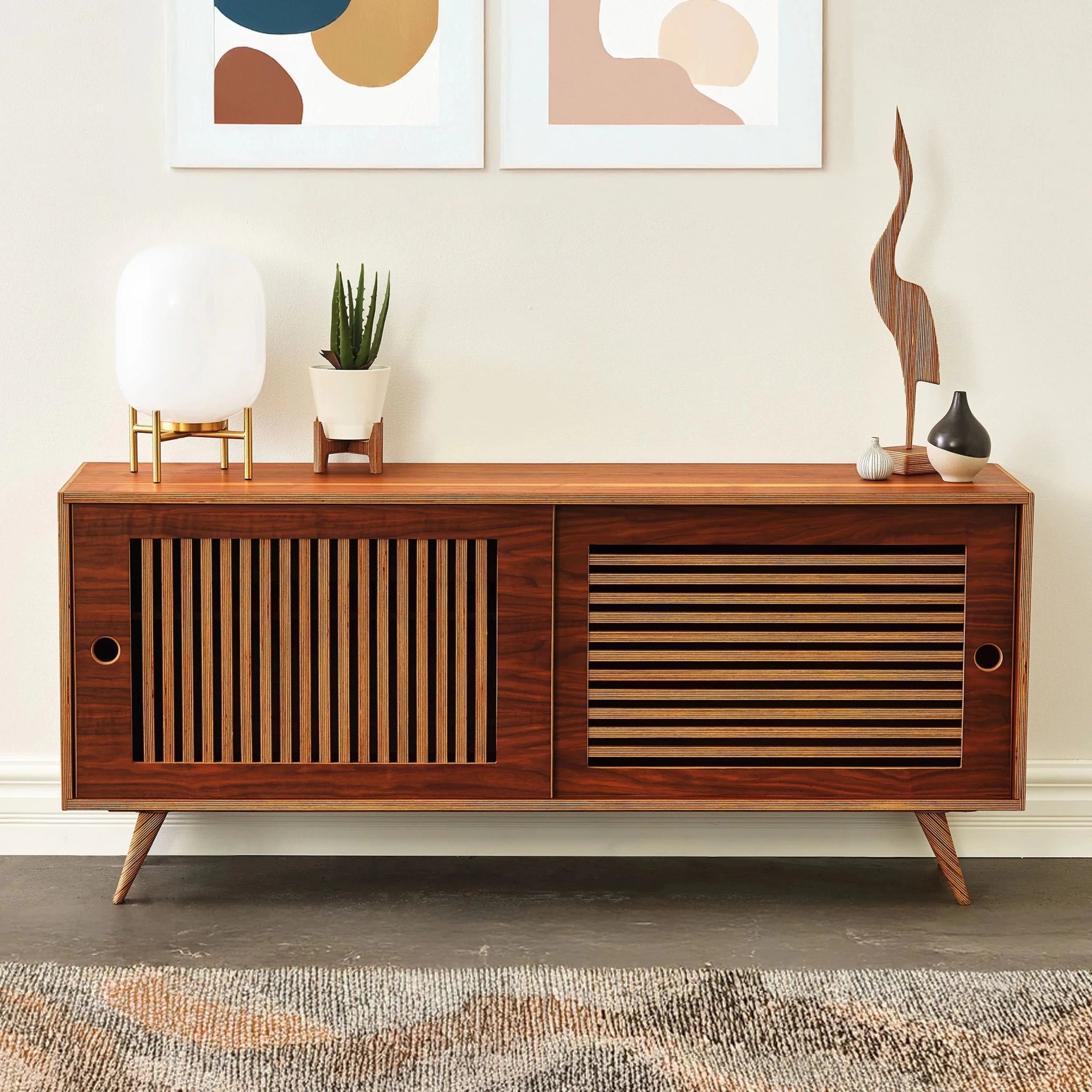 Walnut Media Console No. 1 front, slatted sliding doors, globe lamp, potted aloe, wall art