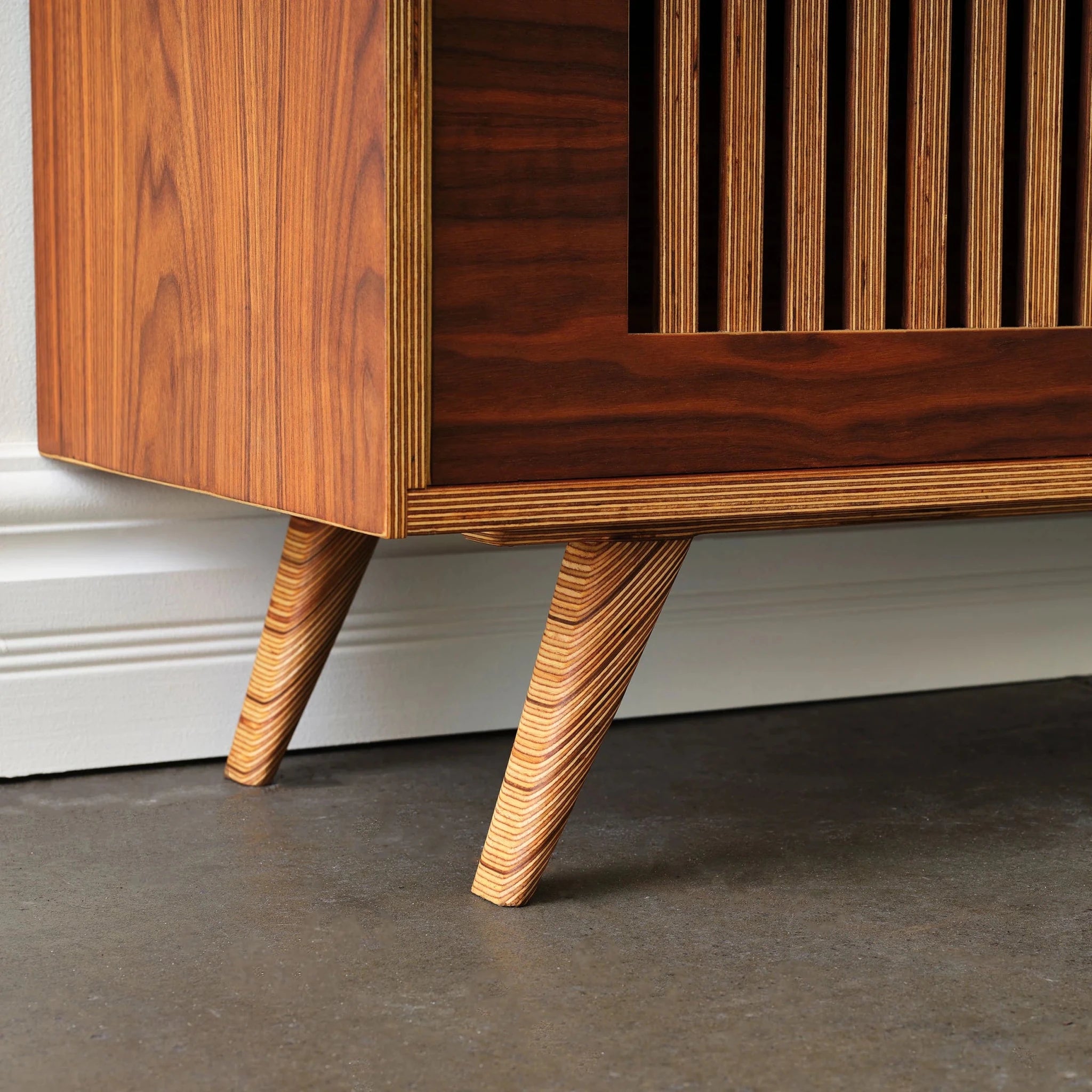 Close-up of media console leg showing Baltic birch plywood layers