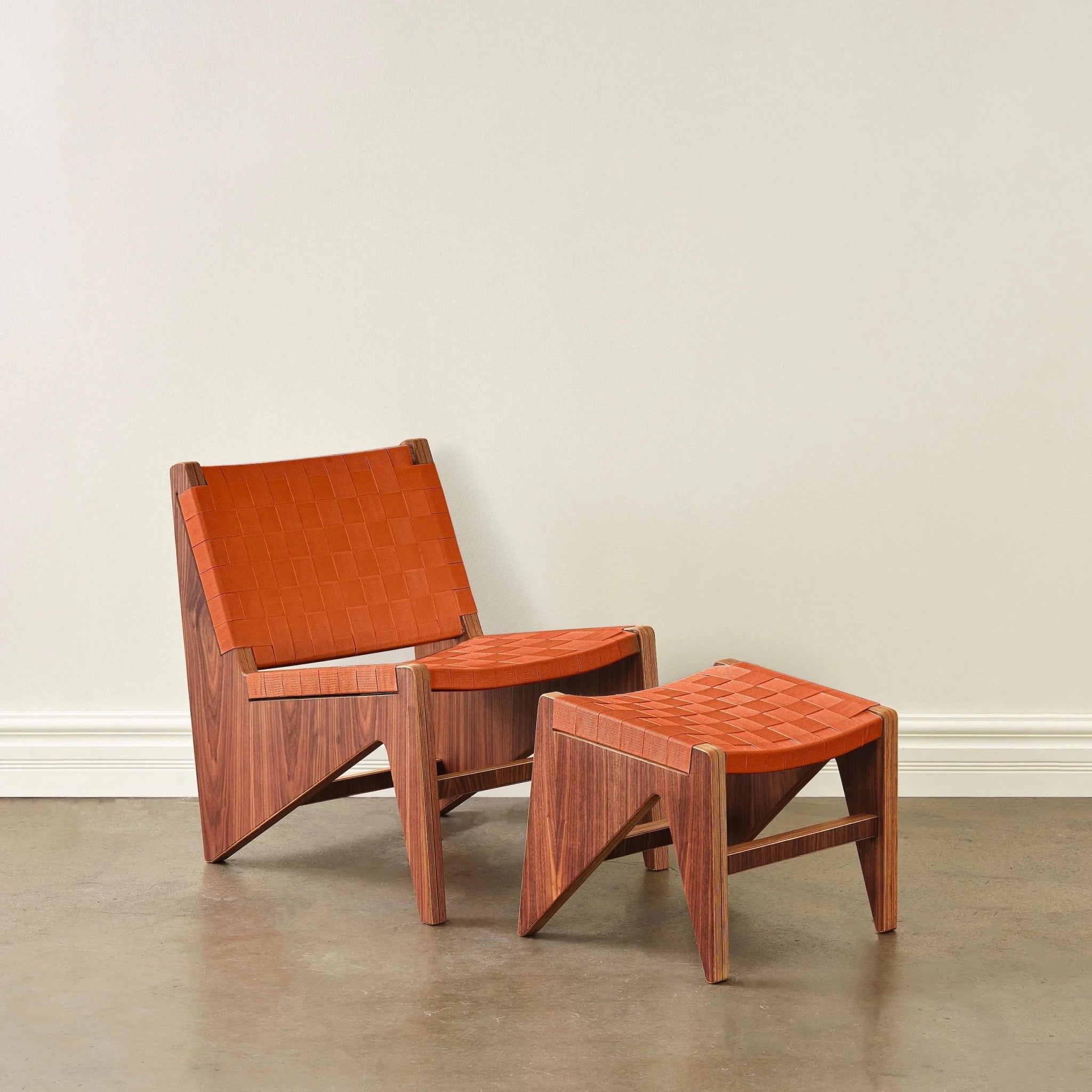 Walnut lounge chair and ottoman with rust-orange woven strap upholstery