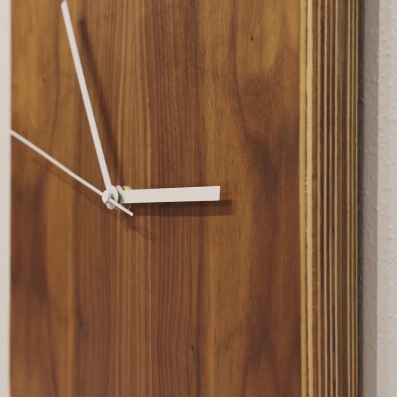 Video thumbnail showing a closeup of a clock with a striped edge and white hands