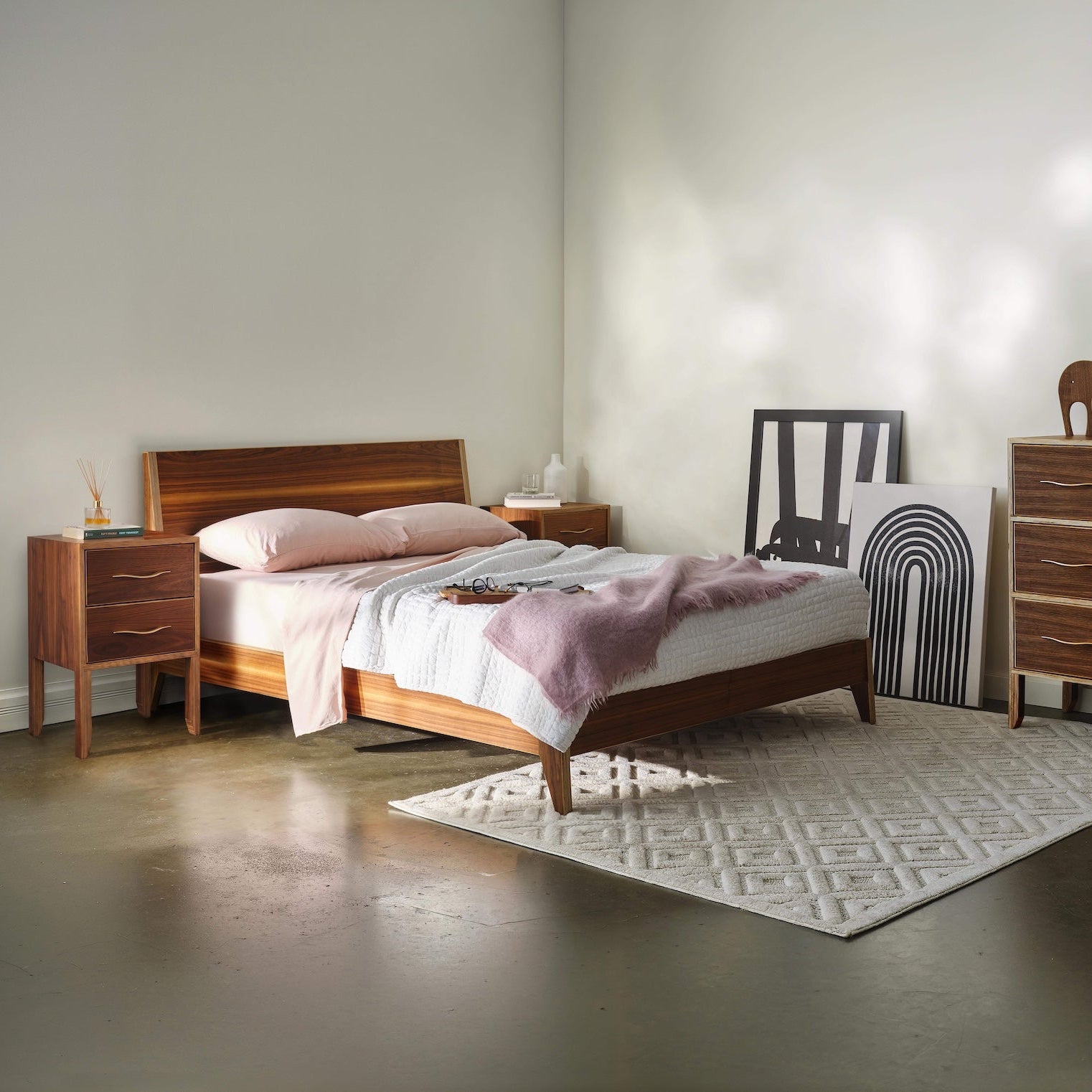 Walnut bedroom set with bed, chest dresser, and two-drawer nightstand, styled room