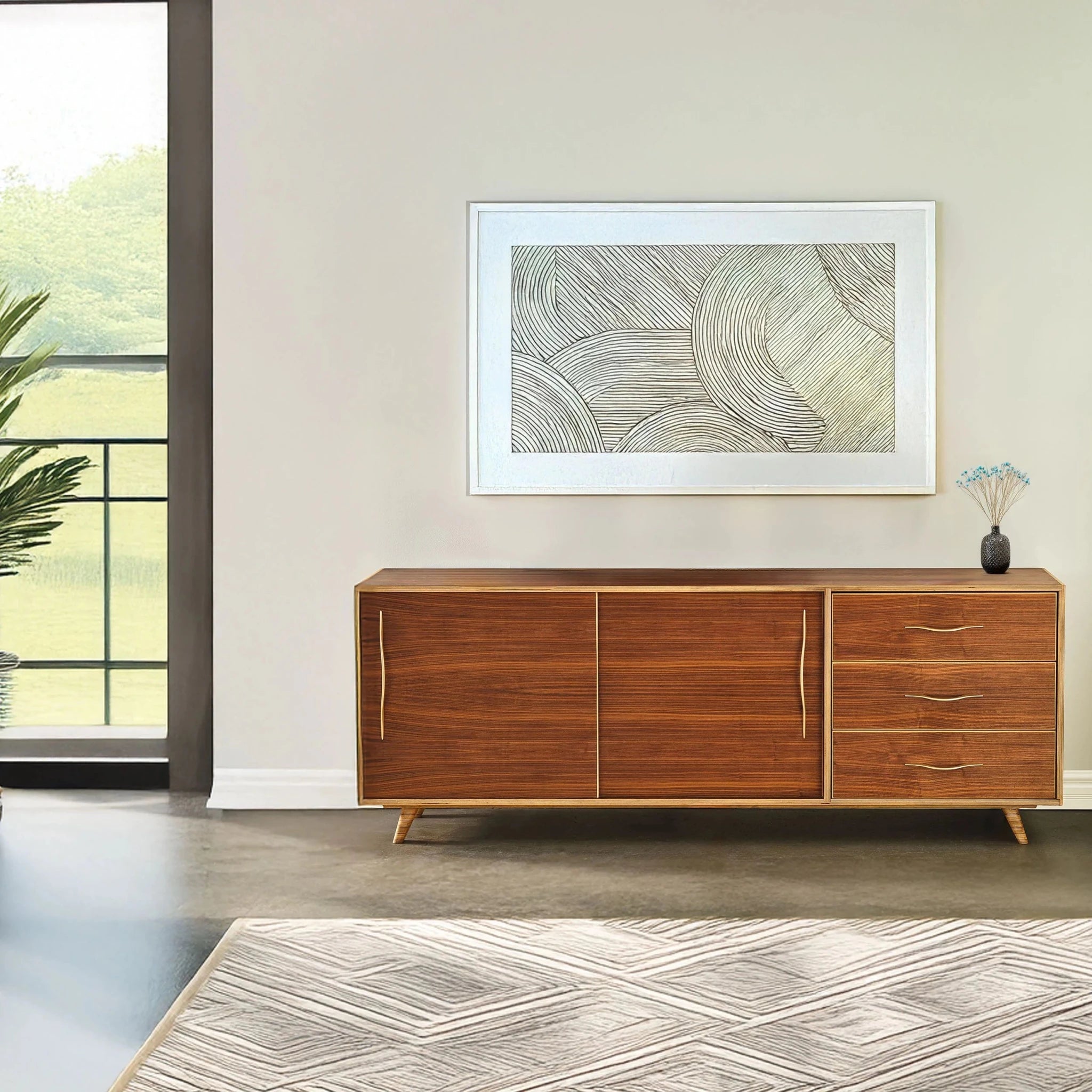 Walnut sideboard styled in bright room with framed art, window and patterned rug