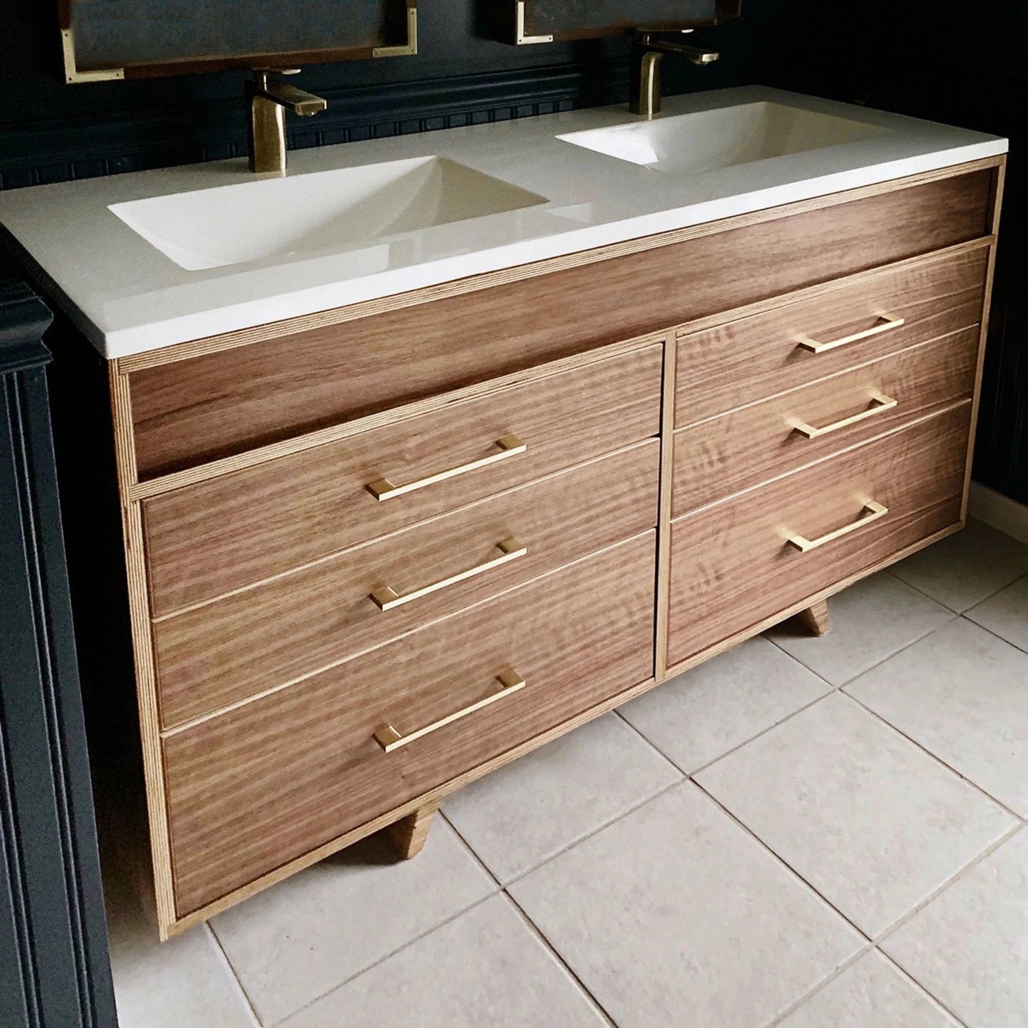 Walnut double vanity, white quartz top, two sinks, brass faucets and pulls, tiled bathroom